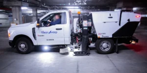 commercial street sweeper cleaning a parking structure exterior - street sweeping schedule