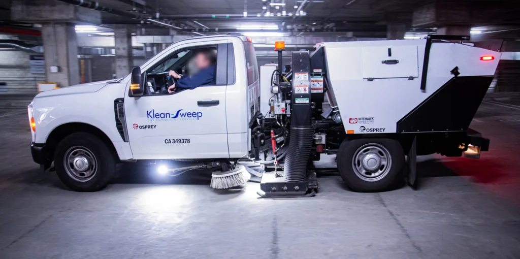 mechanical street sweeper cleaning commercial parking structure - street sweeping